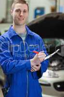 Mechanic writing on clipboard