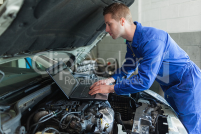 Auto mechanic working on laptop