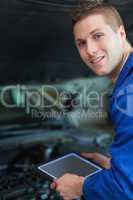 Mechanic holding digital tablet