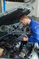 Car mechanic using tablet computer