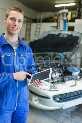 Happy mechanic using tablet computer