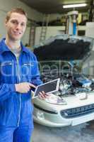 Happy mechanic using tablet computer