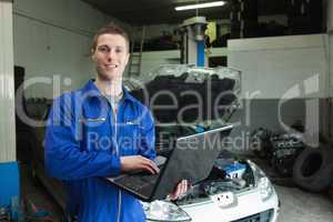 Auto mechanic working on laptop