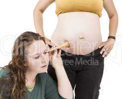 midwife listening at human belly