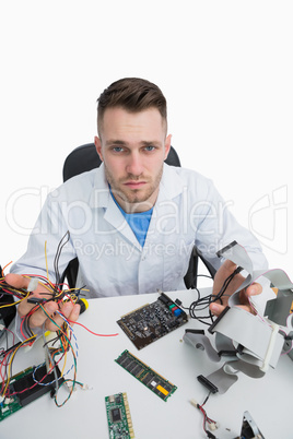 Portrait of confused computer engineer with cpu parts