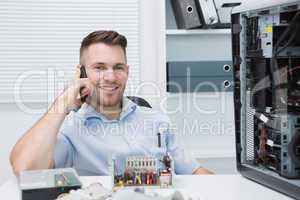 Smiling computer engineer on call by open cpu