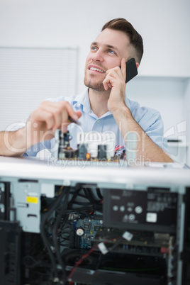 Computer engineer working on cpu part while on call in front of