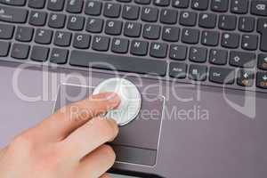 Hand examining touch pad of a laptop with stethoscope