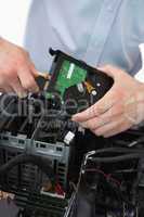Hands fixing cable to hard disk
