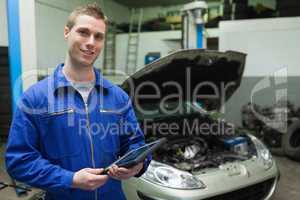 Auto mechanic holding tablet computer