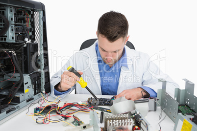 Young computer engineer working on cpu parts