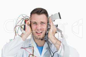 Young it professional yelling with cables in hands