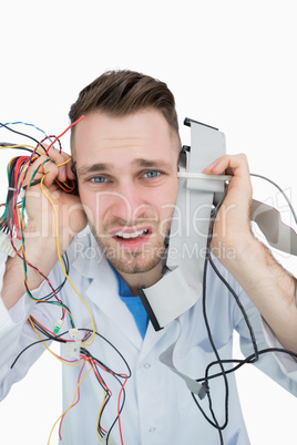 Close-up portrait of it professional yelling with cables in hand
