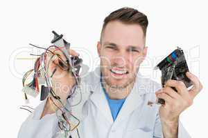 Portrait of young it professional yelling with cpu parts in hand