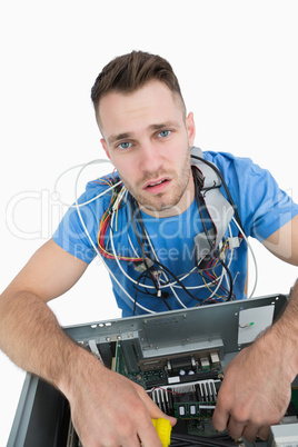 Portrait of tired it professional with cables around neck