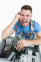 Frustrated computer engineer screaming over the phone in front o