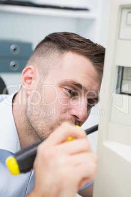 Computer engineer with screw driver fixing cpu