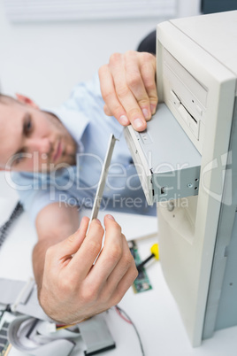 Computer engineer fixing cd/dvd player into computer case