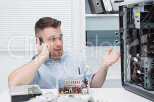 Computer engineer on call as he gestures towards an open cpu