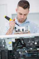 Computer engineer working on cpu part in front of open cpu