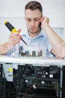 Computer engineer working on cpu part while on call in front of