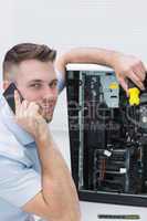 Portrait of computer engineer working on cpu while on call