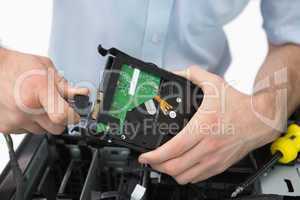 Hands fixing cable to hard disk