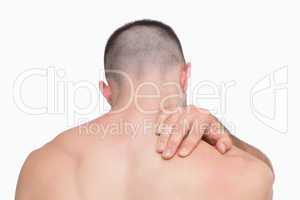 Rear view of shirtless man with neck pain