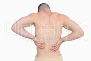 Rear view of shirtless man with back pain