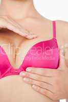 Woman performing self breast examination