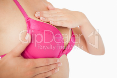 Close-up of woman performing self breast examination