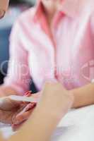 Woman filing fingernail