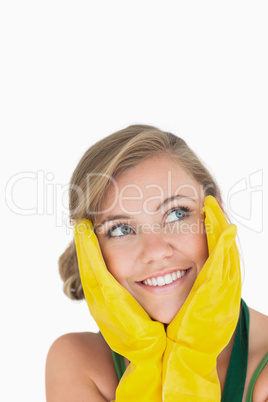 Close-up of smiling young maid with yellow gloves