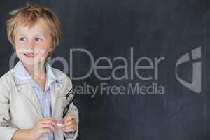 Boy dressed as teacher standing in front of black board