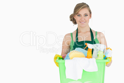 Portrait of young maid carrying cleaning supplies