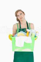 Tied young maid carrying cleaning supplies
