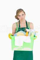 Portrait of tied maid carrying cleaning supplies