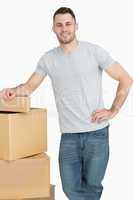 Portrait of smiling young man with cardboard boxes