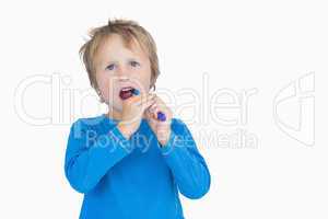 Young boy brushing his teeth