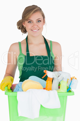 Portrait of young maid carrying cleaning supplies