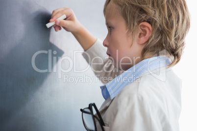 Boy dressed as teacher and writes on black board