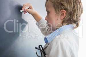 Boy dressed as teacher and writes on black board