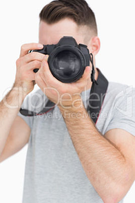 Young male photographer with photographic camera