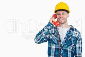 Portrait of male architect using landline phone