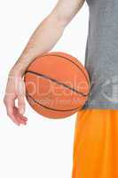 Close-up midsection of man with basketball