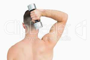 Rear view of man exercising with dumbbell