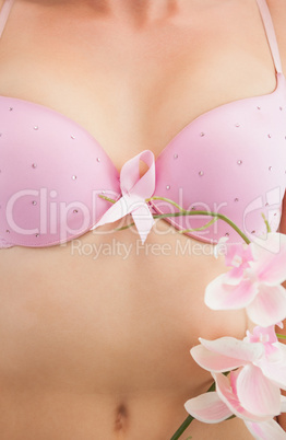 Woman with breast cancer awareness ribbon and flower