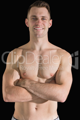 Portrait of bare chested young man with arms crossed