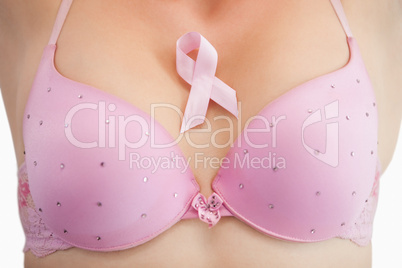 Woman in bra with breast cancer awareness ribbon