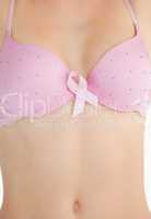 Woman in bra with breast cancer awareness ribbon